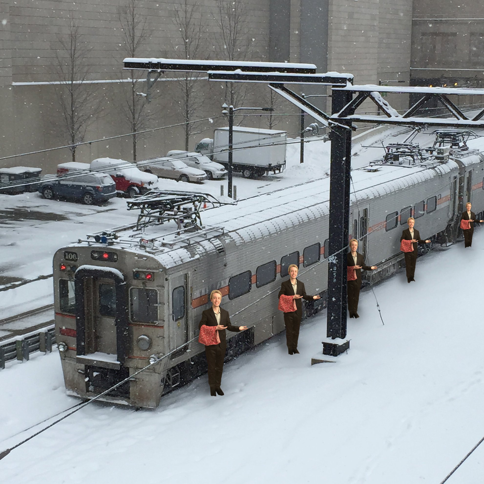 Six butler outside in the snow standing in front of a train in a snowy landscape